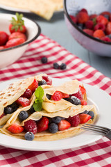 Delicious pancakes with raspberries, blueberries and strawberrie