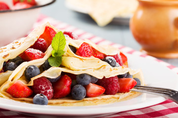 Delicious pancakes with raspberries, blueberries and strawberrie
