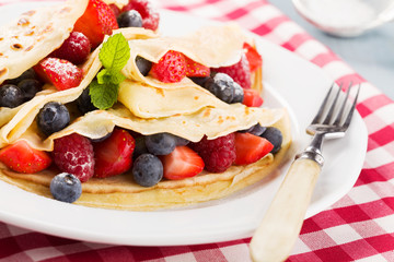 Delicious pancakes with raspberries, blueberries and strawberrie