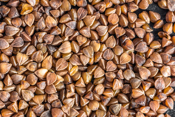 Raw grain of cereal - buckwheat background texture