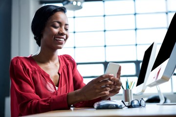 Woman text messaging on mobile phone