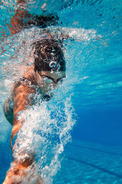Swimming freestyle, action shot, underwater closeup