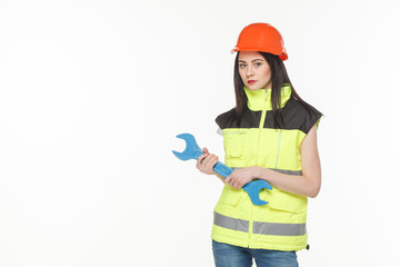 girl in a yellow vest with the tool