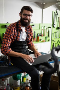 Bike mechanic using laptop