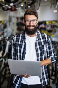 Bike mechanic checking laptop