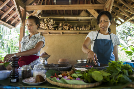 Asian chefs cooking in outdoor kitchen 