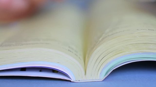 A man using a phone book looking glasses