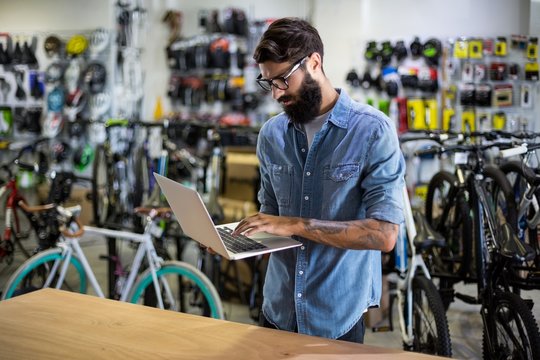 Bike mechanic checking at laptop
