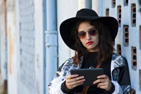 modern girl with the tablet on the street