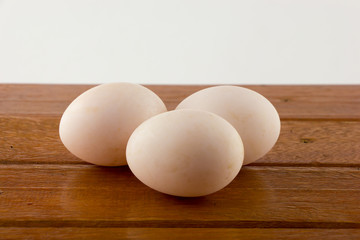 Duck eggs on wooden table 