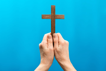 Jesus hand and cross on blue background