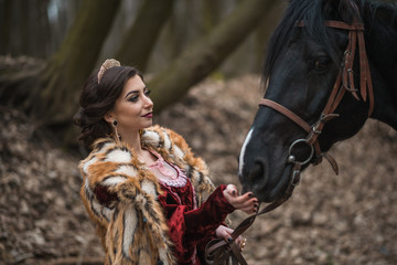 Princess with her horse in the woods
