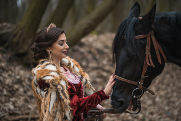 Fototapeta na wymiar Princess with her horse in the woods