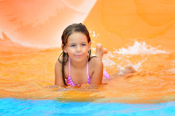 Adorable toddler girl enjoying her summer vacation at aquapark