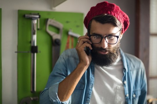 Bike Mechanic Having A Phone Call