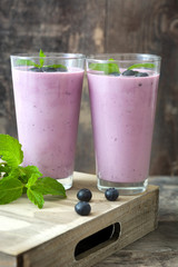 Fresh blueberry smoothie on rustic wood
