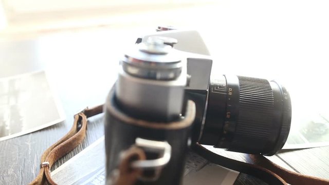 Old camera on a wooden table