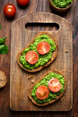 Appetizer pesto sauce and tomatoes on bread