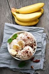 Banana ice cream in bowl on country table