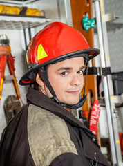 Confident Male Firefighter Against Firetruck