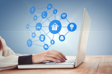 Composite image of hipster businesswoman using her laptop