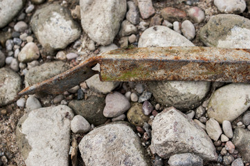 rusty metal on stones