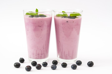 Fresh blueberry smoothie on white background
