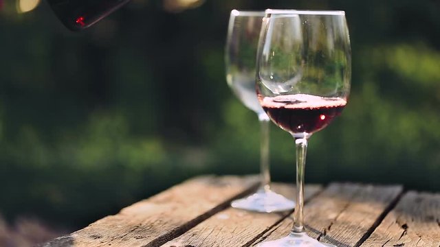 Red wine poured into glass.