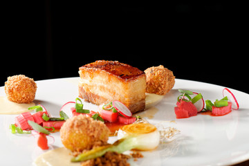 Plated freshly grilled pork bellies with rhubarb vegetable