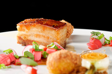 Plated freshly grilled pork bellies with rhubarb vegetable