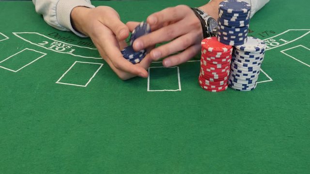 Man Shuffling Poker Chips