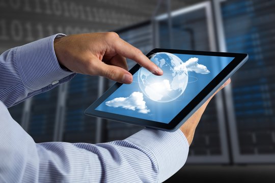 Composite image of man using tablet pc
