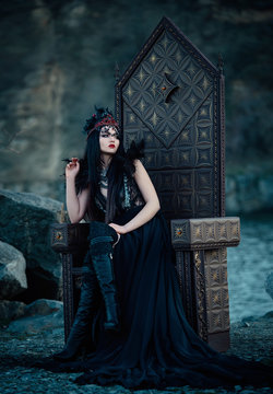 .dark evil queen sitting on a luxurious throne,dark boho, cosplay to the film SNOW WHITE AND THE HUNTSMAN ,wild Princess , vampire , hip toning , creative color.