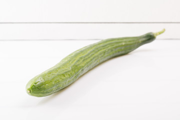 Ripe fresh cucumber on a white background