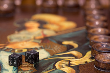 two dice and chips on the backgammon table