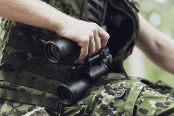close up of soldier or hunter with binocular