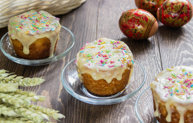 Traditional Easter cake with glace icing and painted easter eggs.Rustic style. Easter arrangement