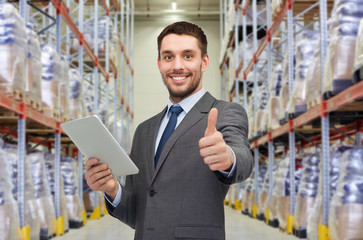 businessman with tablet pc over warehouse