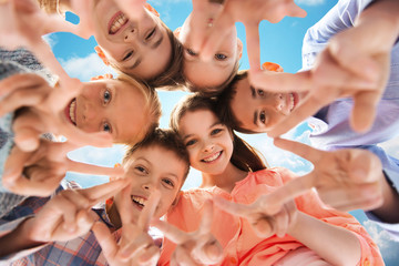happy children showing peace hand sign
