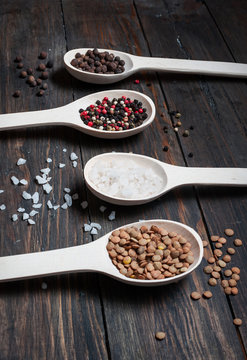 Spice in Wooden spoon on a wooden background. Pepper
