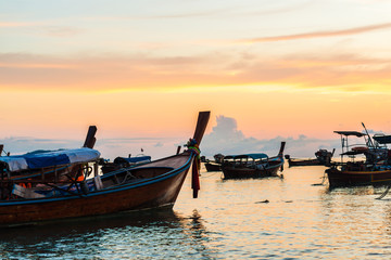 Fototapeta premium Fishing boat on beach silhouette in sunset light