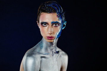 Crazy young androgyne man with face art and closed eyes. SPACEMAN. Freak person. Sperm on face....
