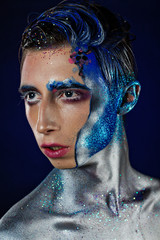 Crazy young androgyne man with face art and closed eyes. SPACEMAN. Freak person. Sperm on face....