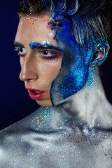 Crazy young androgyne man with face art and closed eyes. SPACEMAN. Freak person. Sperm on face....