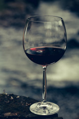 Red wine glass near water