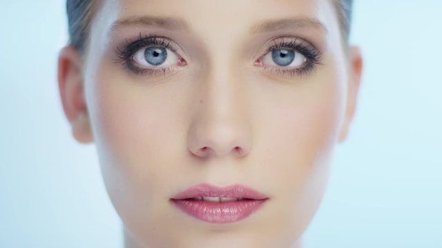 Stunning young woman opens her eyes and looks from left to right