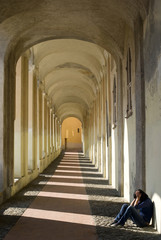 Sad girl sitting against wall
