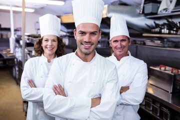 Team of chefs standing with arms crossed