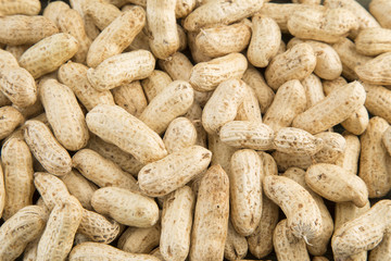 Peanuts in shells on wood background