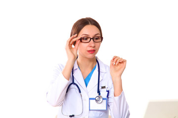 Fototapeta premium Portrait of young female doctor sitting at desk in hospital